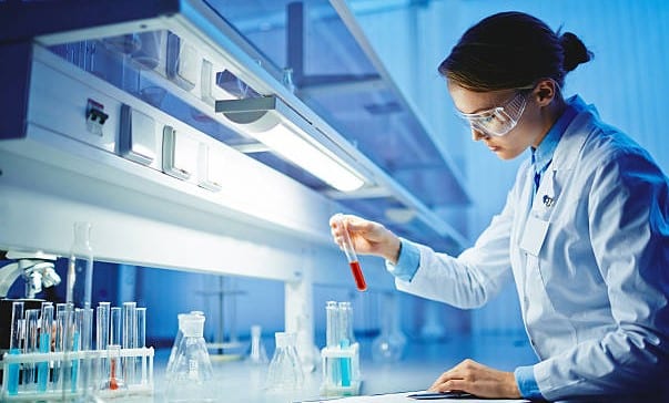 scientist working in a lab with test tubes - china cosmetics regulation 
