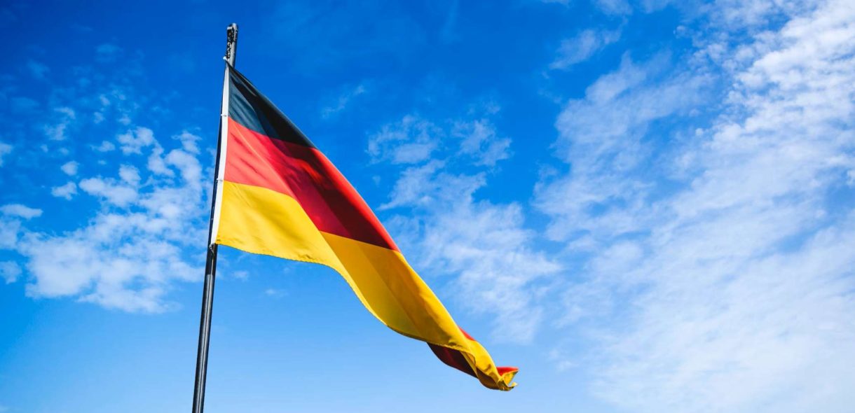 image of the German flag blowing in the wind - German packaging act verpackg