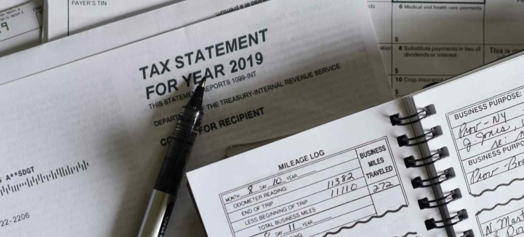 a tax statement with a pen on top of it - Requirements for Packaging and Plastic Tax in Spain
