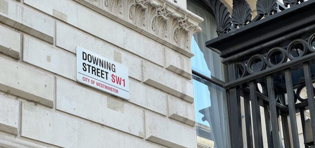 A sign on a building reading "Downing Street"