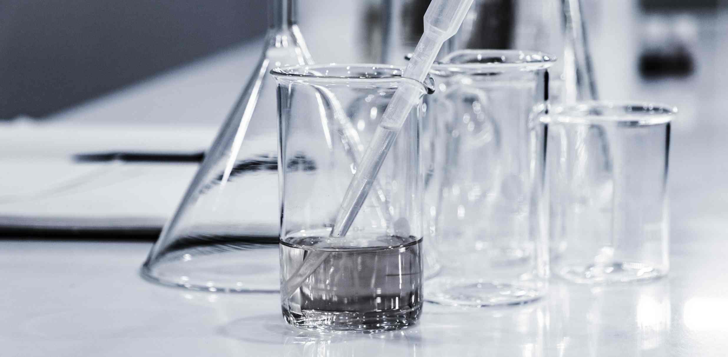 laboratory glass jars on a white table