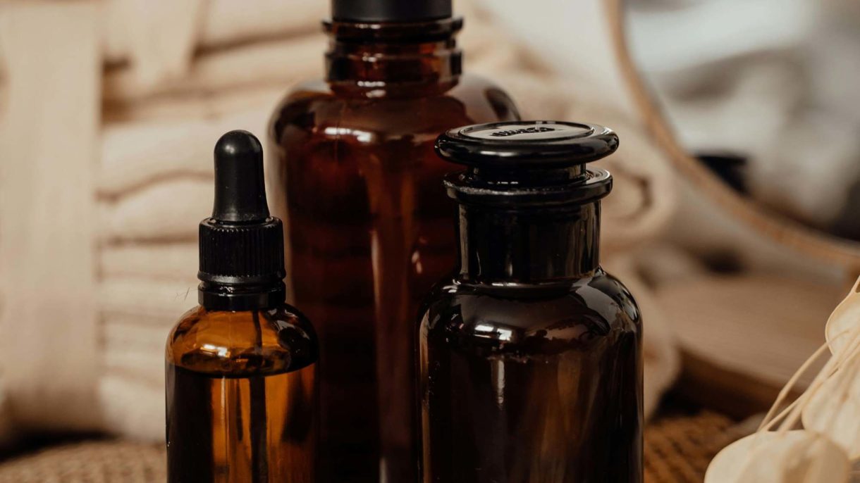 Close-up of three glass bottles of cosmetic products