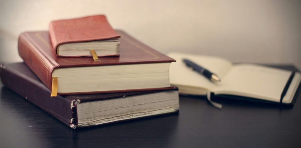 A stack of three books on a table - cbd cosmetics regulations
