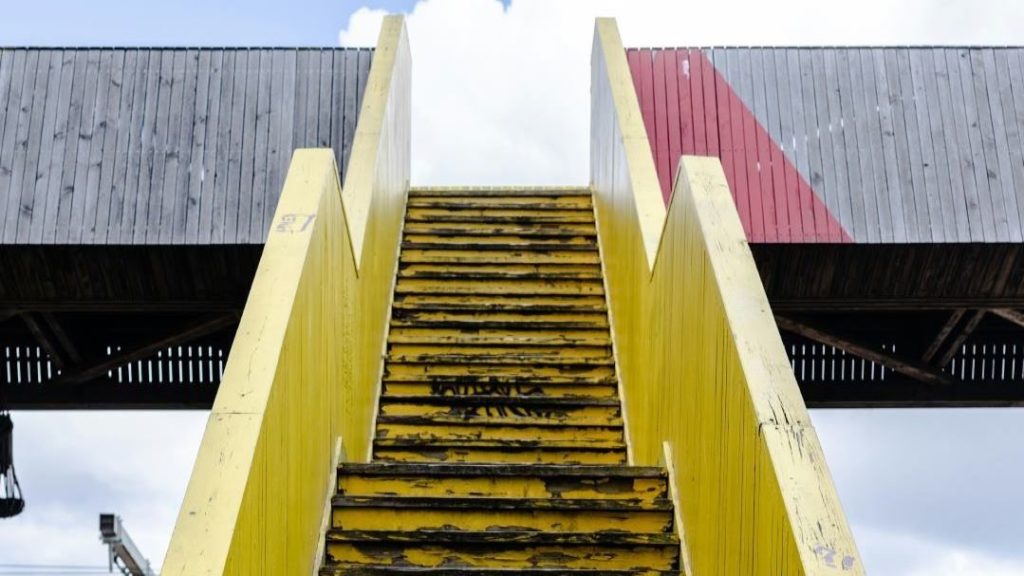 Yellow stairs leading up to a walkway - CLP products