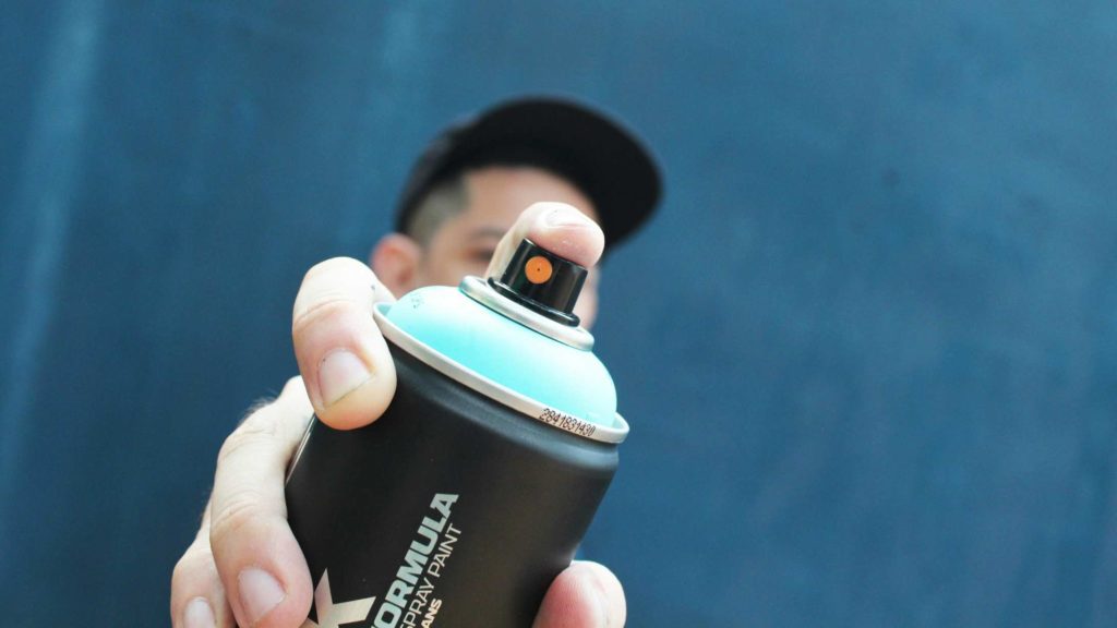 close-up shot of an aerosol disperser held by a man