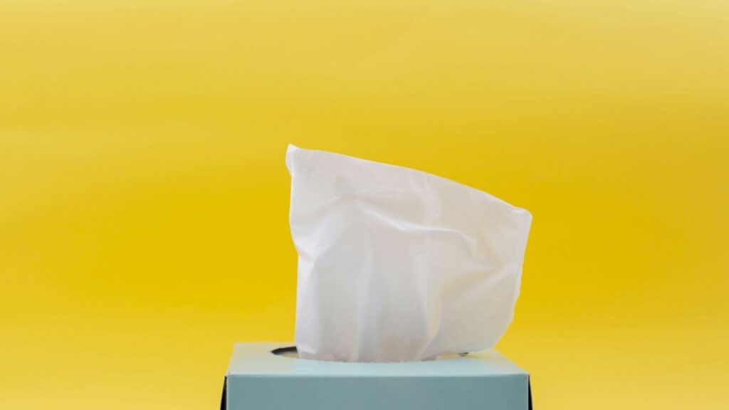 close-up of a box of wet wipes on a yellow background