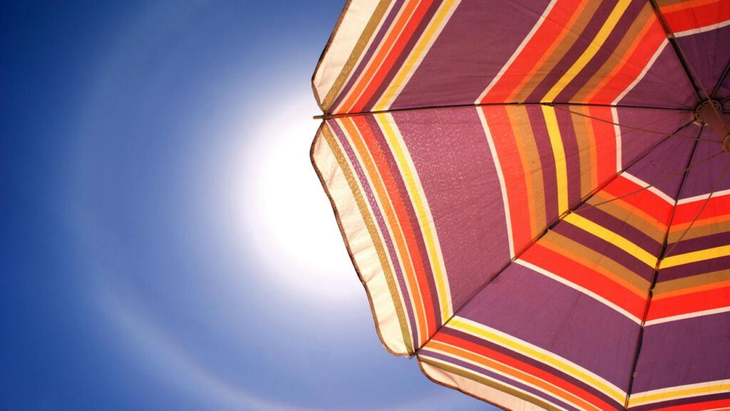 part of a beach umbrella on a clear, sunny sky