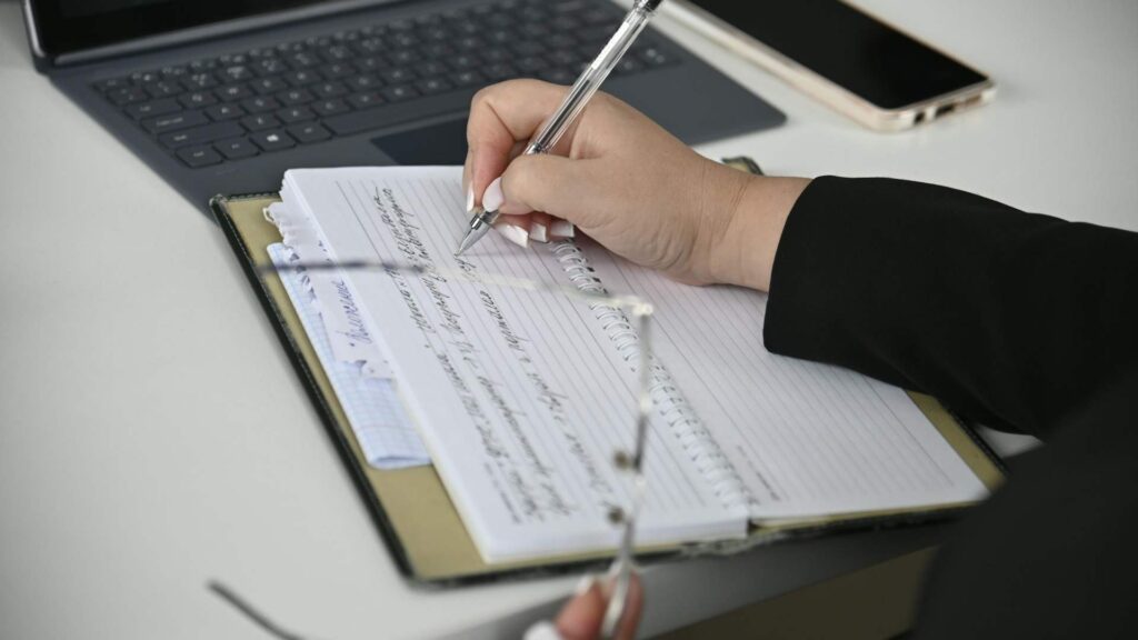 close-up image of a business person writing a report