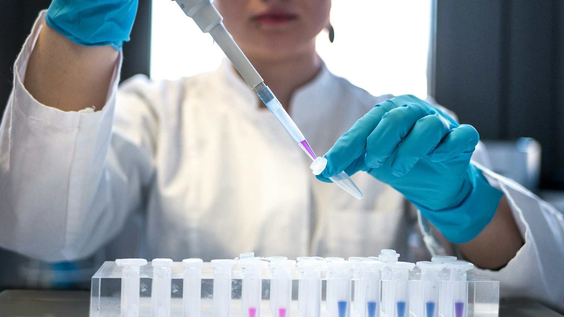 close-up image of a lab scientist testing cosmetic products
