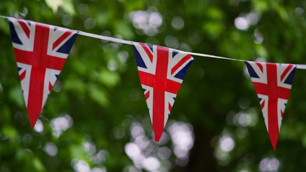 Three pennons with the UK Union Jack hanging on a string